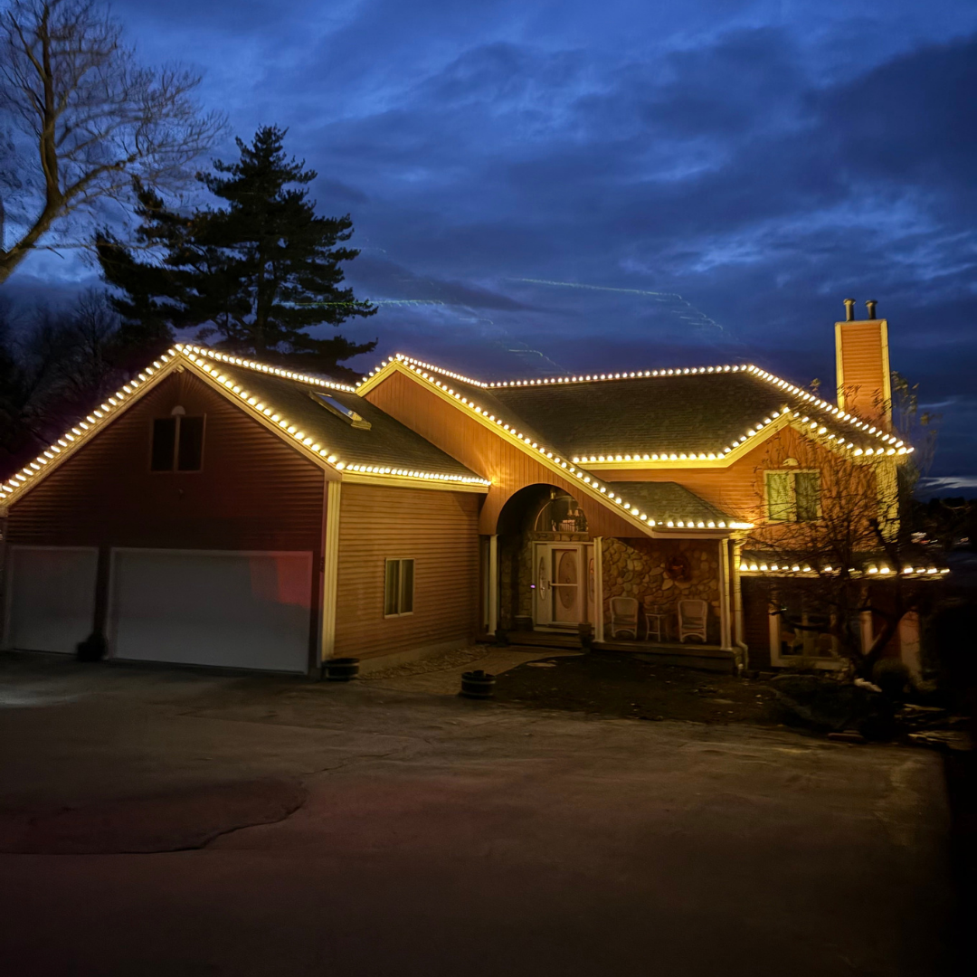 New Hampshire home withe decorative Christmas lights professionally installed by Hewson Electric
