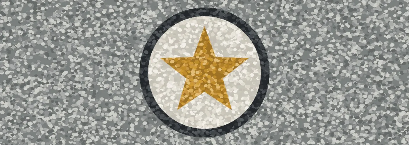 A star inlaid in gold stone inside a dark ring on a grey stone walkway