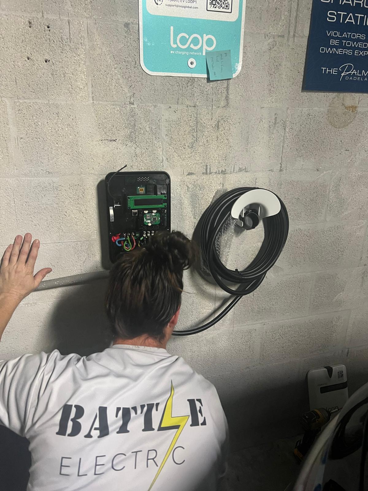 Battle Electric technician working on an EV charger installation