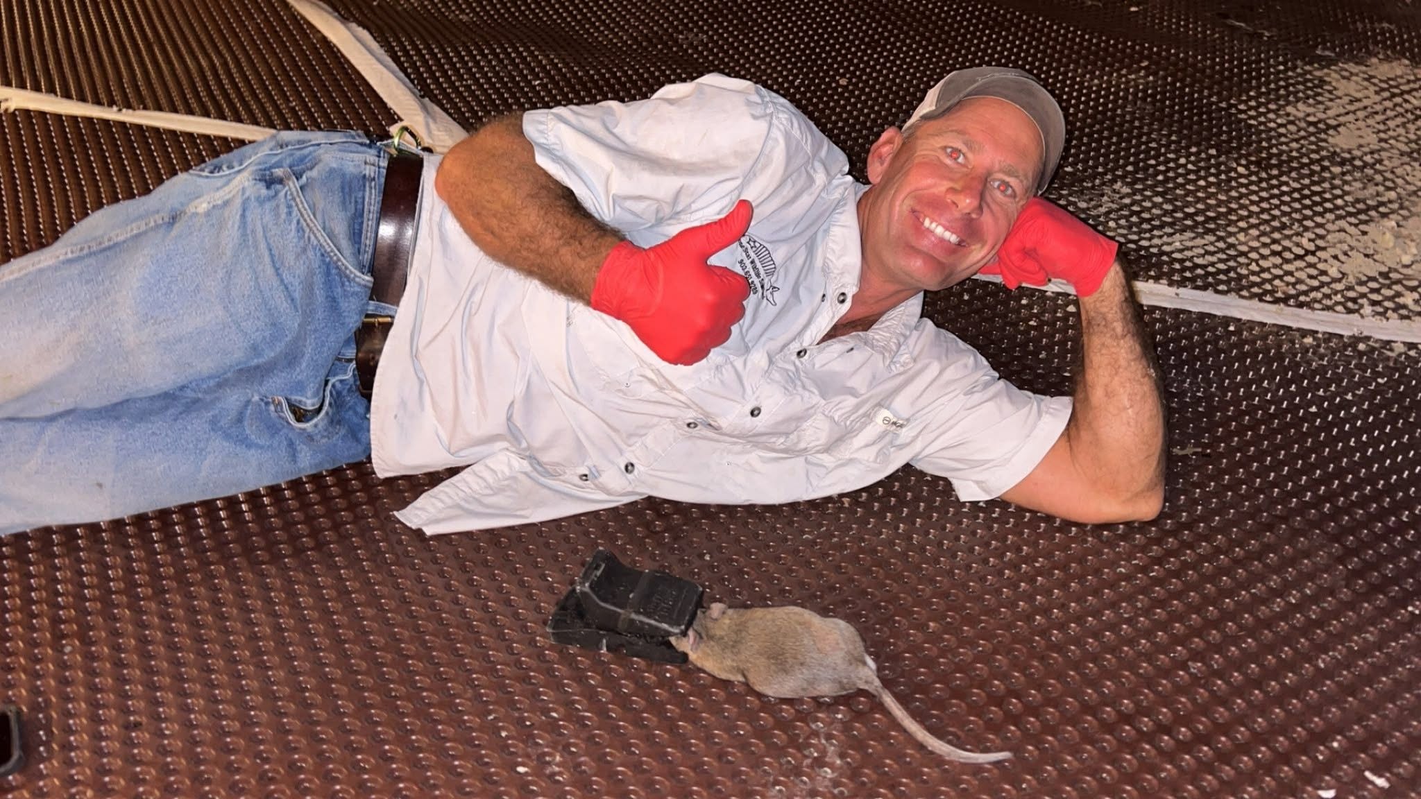 Lone Star Wildlife Solutions technician with captured rat after successful removal from residential property