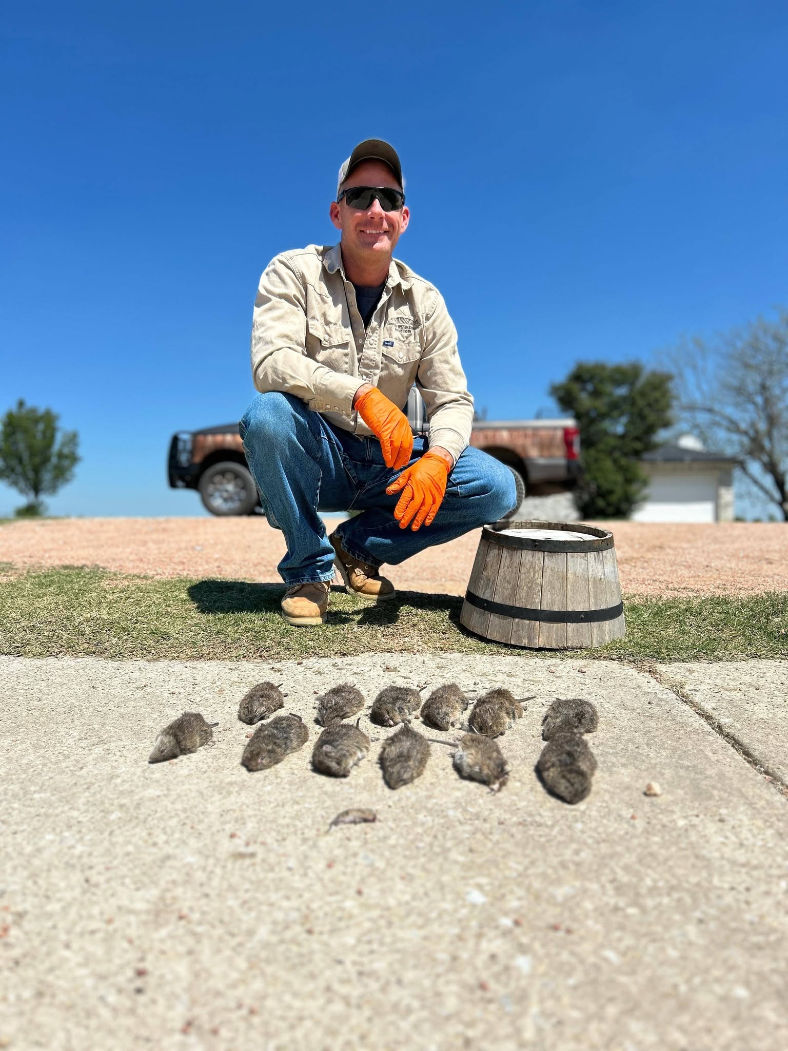 Lone Star Wildlife Solutions technician with captured rat after successful removal from residential property