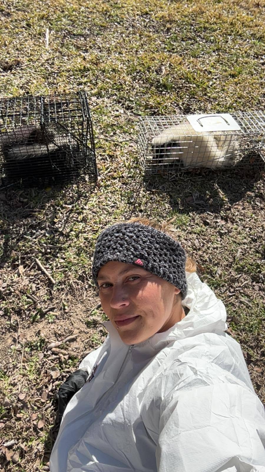 Lone Star Wildlife Solutions technician with captured skunk after successful removal from residential property