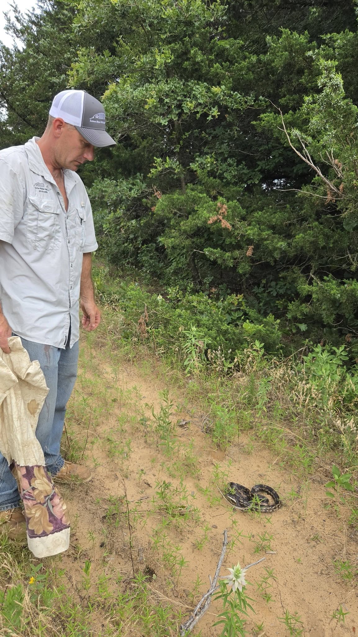 Lone Star Wildlife Solutions technician with captured snake after successful removal from residential property