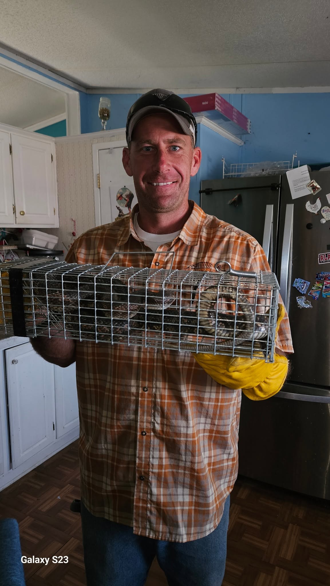 Lone Star Wildlife Solutions technician with captured snake after successful removal from residential property