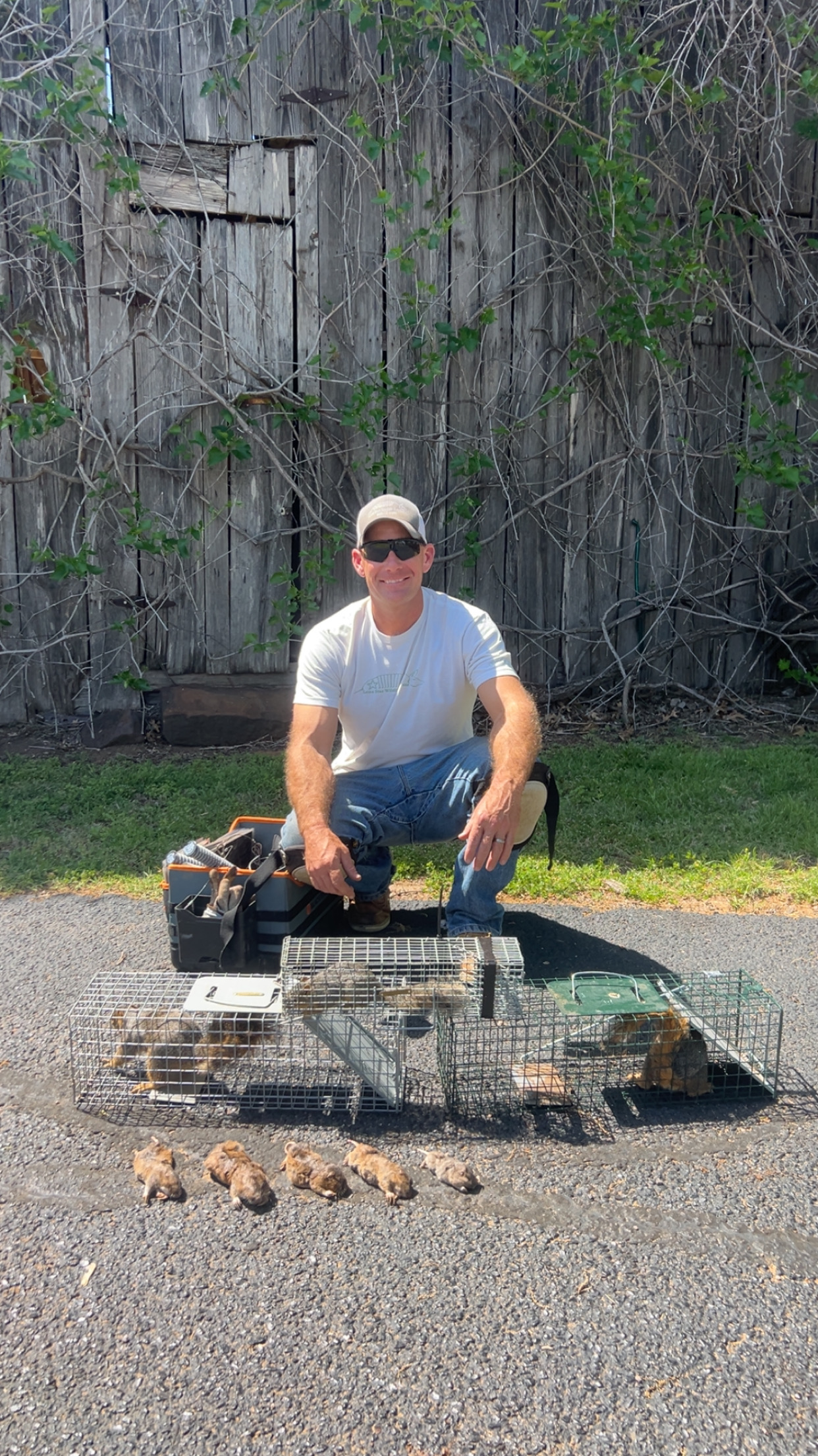 Lone Star Wildlife Solutions technician with captured squirrel after successful removal from residential property