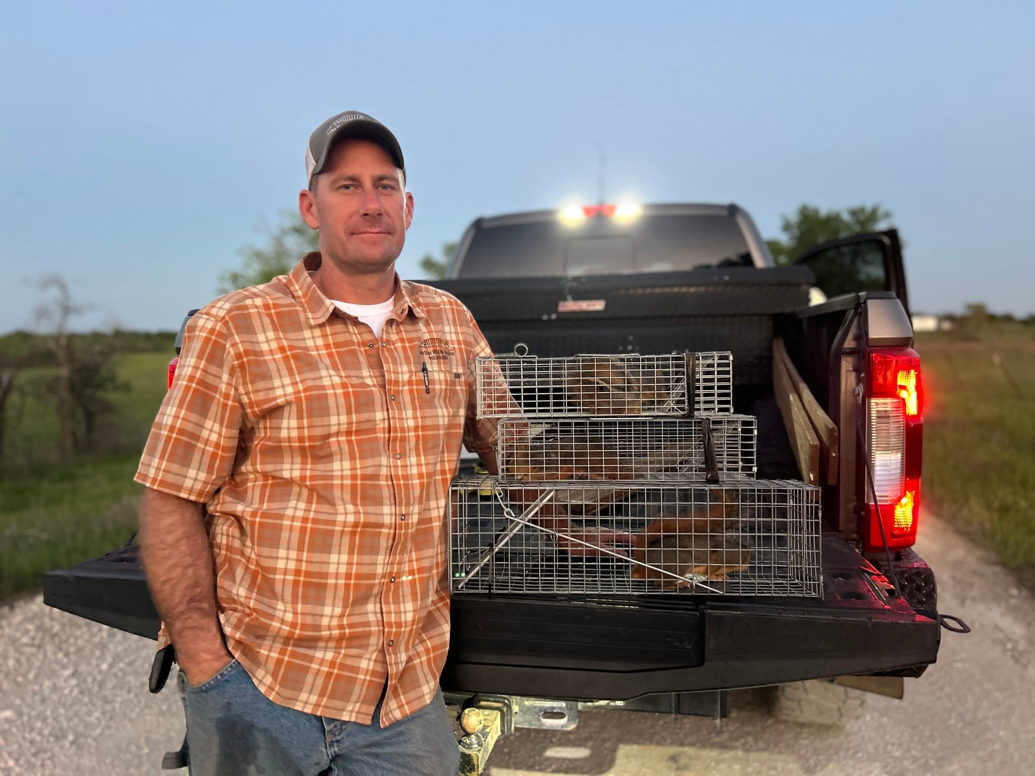 Lone Star Wildlife Solutions technician with captured squirrel after successful removal from residential property