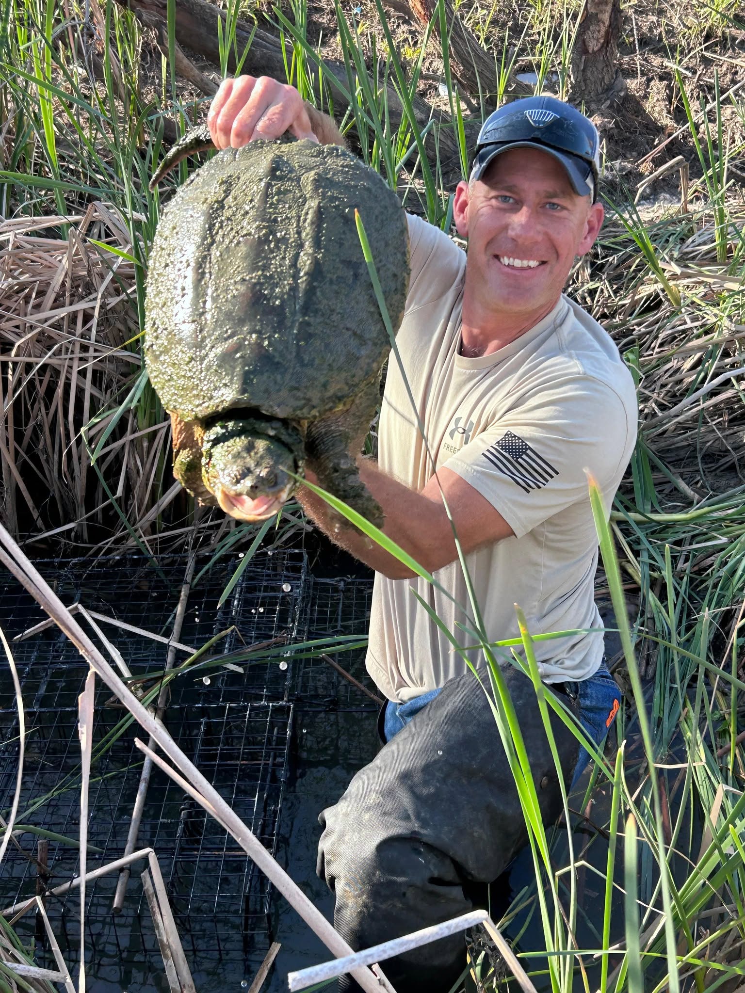 Lone Star Wildlife Solutions technician with captured turtle after successful removal from residential property
