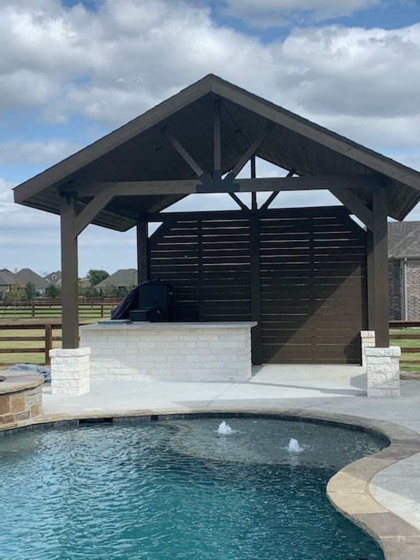 Covered outdoor kitchen and patio by Make Me A Fence in Argyle, Texas