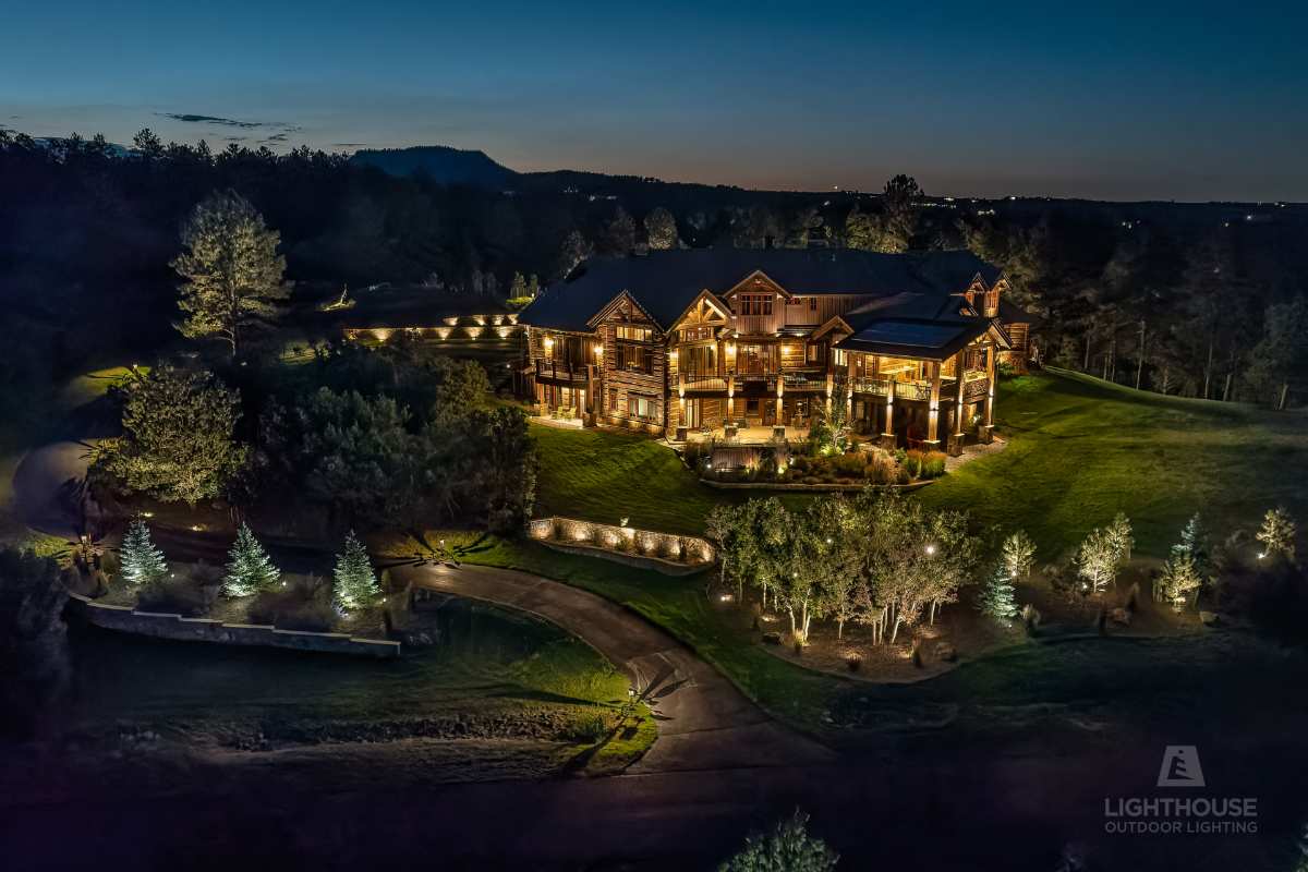 Estate home lit with warm architectural lighting at dusk