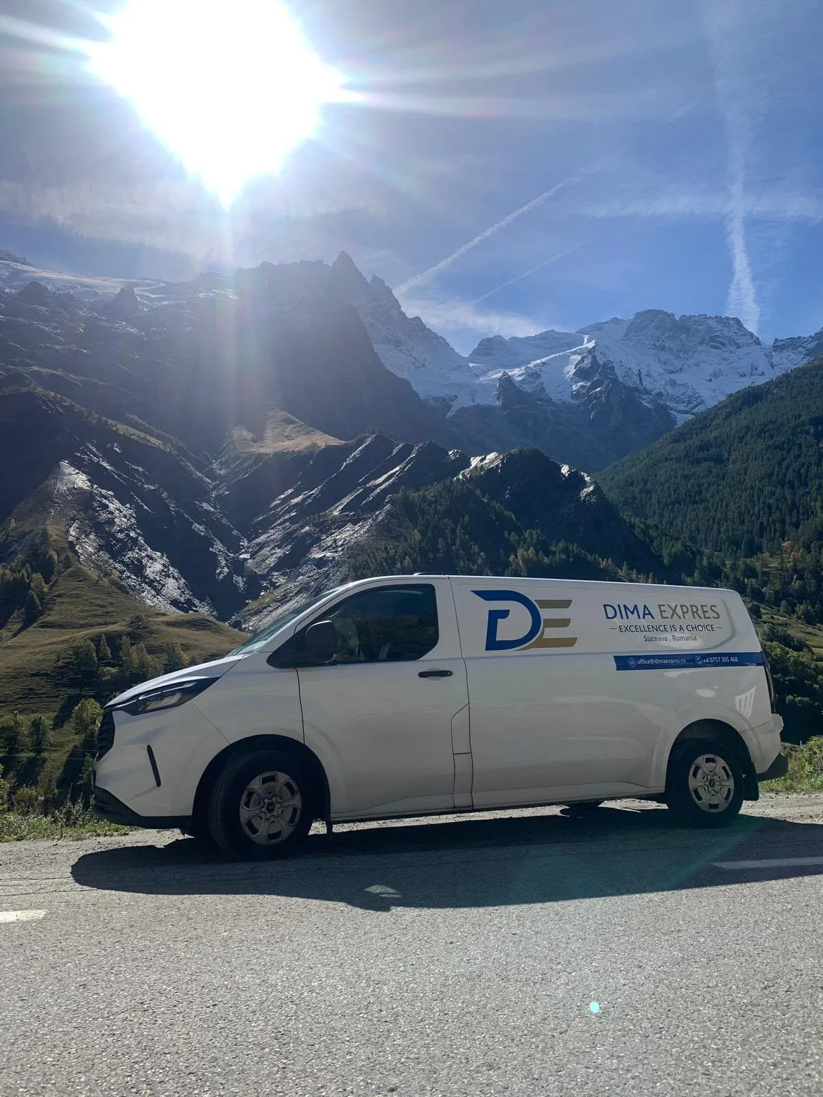 Dima Expres van on a mountain road in the Alps