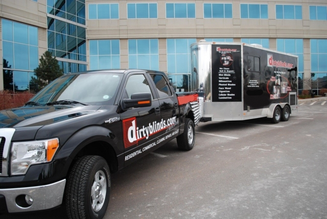 Owners with their DirtyBlinds.com mobile cleaning trailer