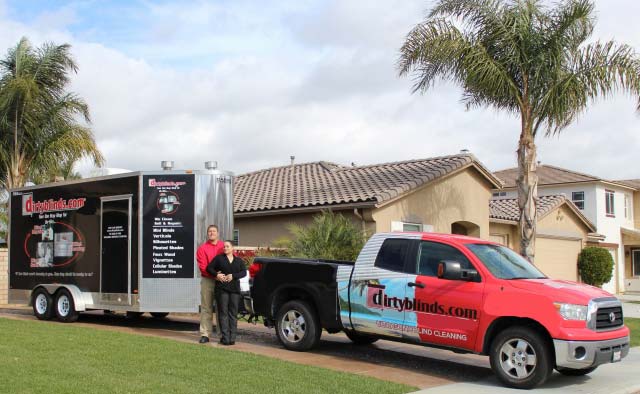 Andy and Heidi Robinson with their DirtyBlinds.com trailer