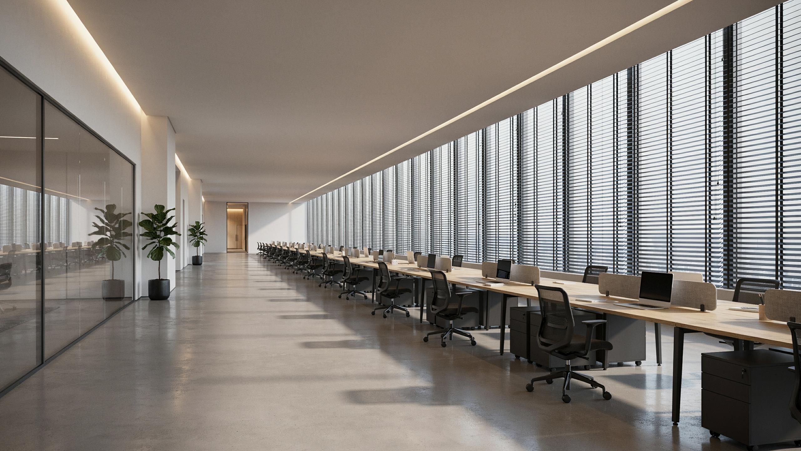 A large corporate office with a long wall of windows fitted with blinds