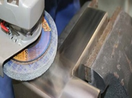 Grinding wheel finishing a stainless steel weld