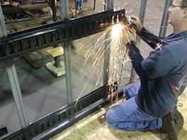 E-track being welded to a blind cleaning trailer frame
