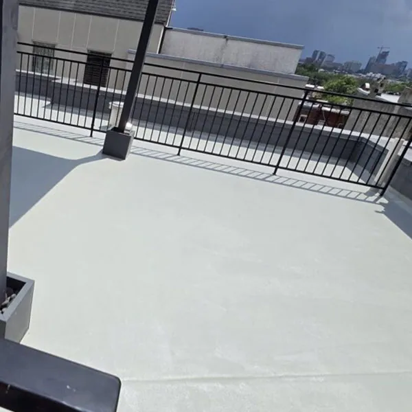 Roofing contractor fiberglass in Phoenixville applying protective roof coating.