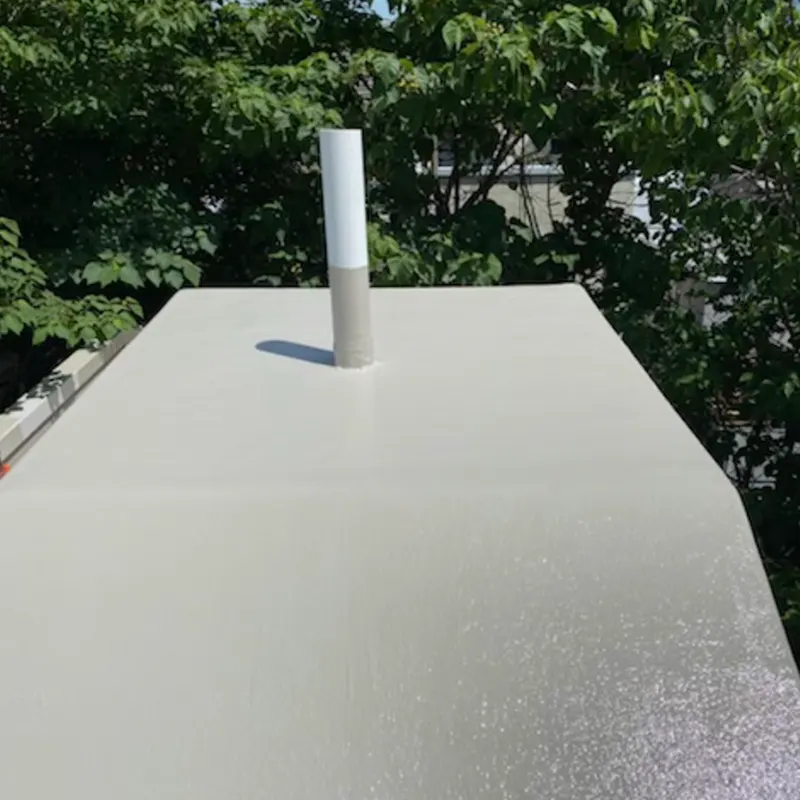 Professional applying fiberglass roofing material during repair process.