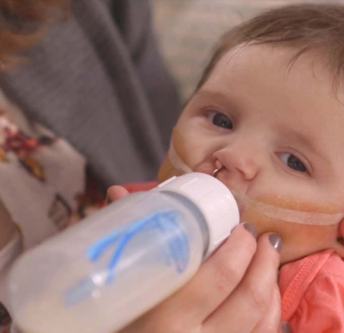 Baby being fed with a Dr. Brown's specialty feeding bottle