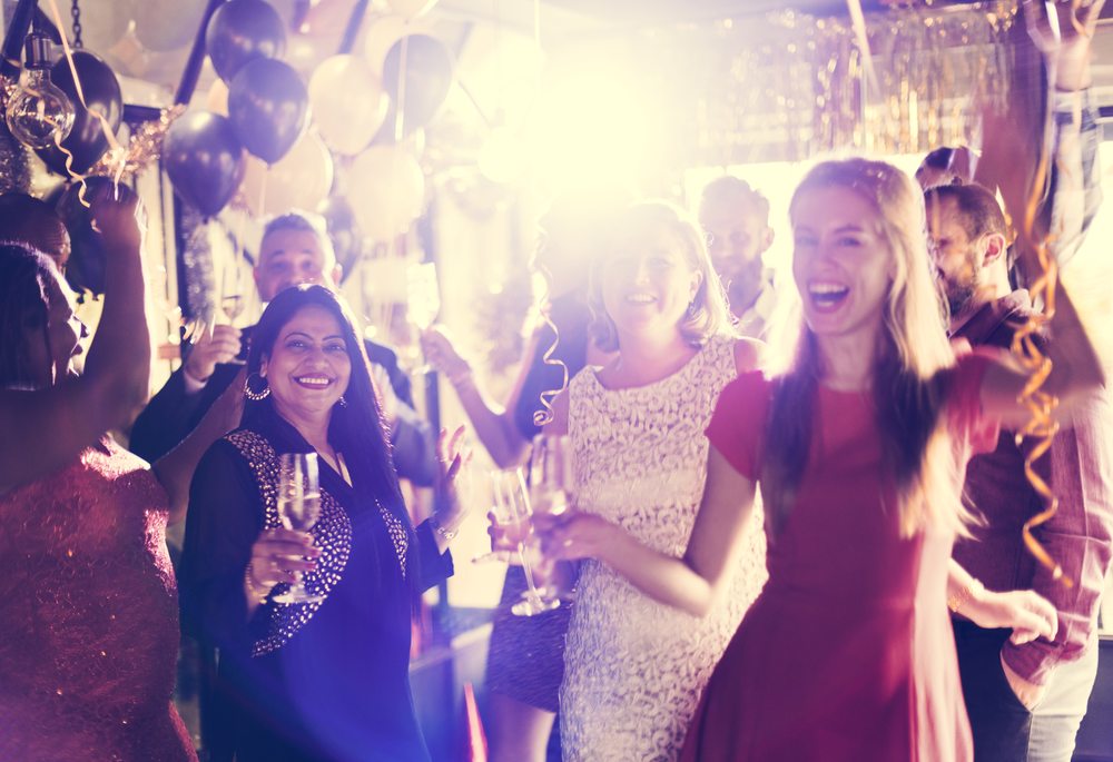 Friends celebrating together with balloons and confetti