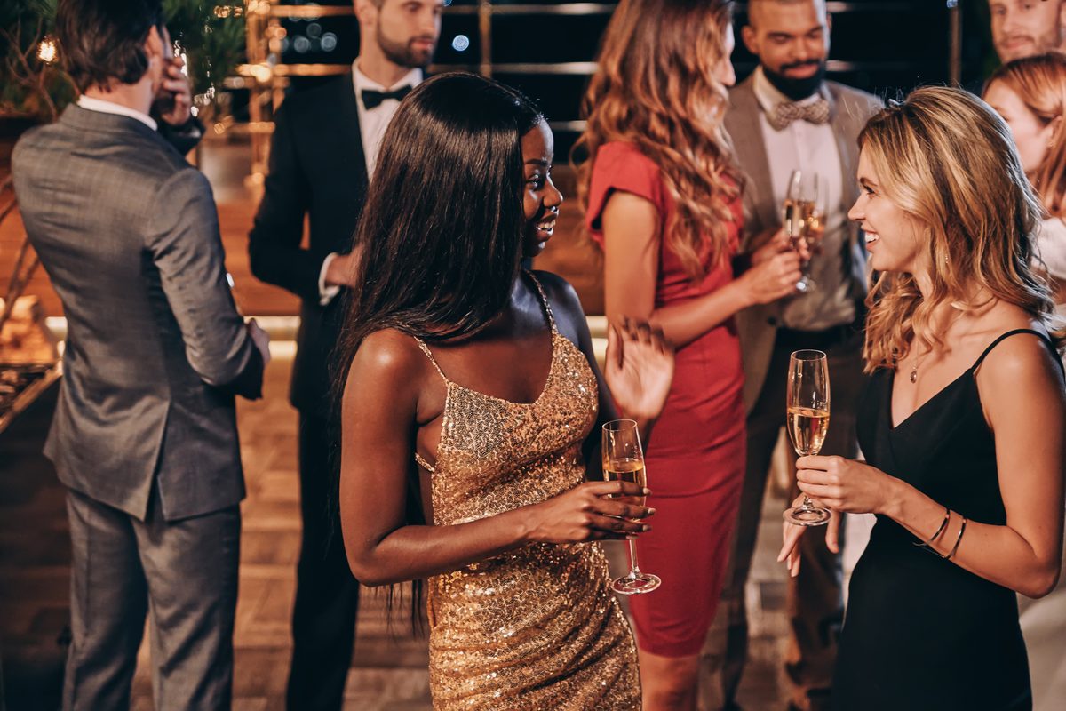 Guests chatting and enjoying drinks at an evening celebration