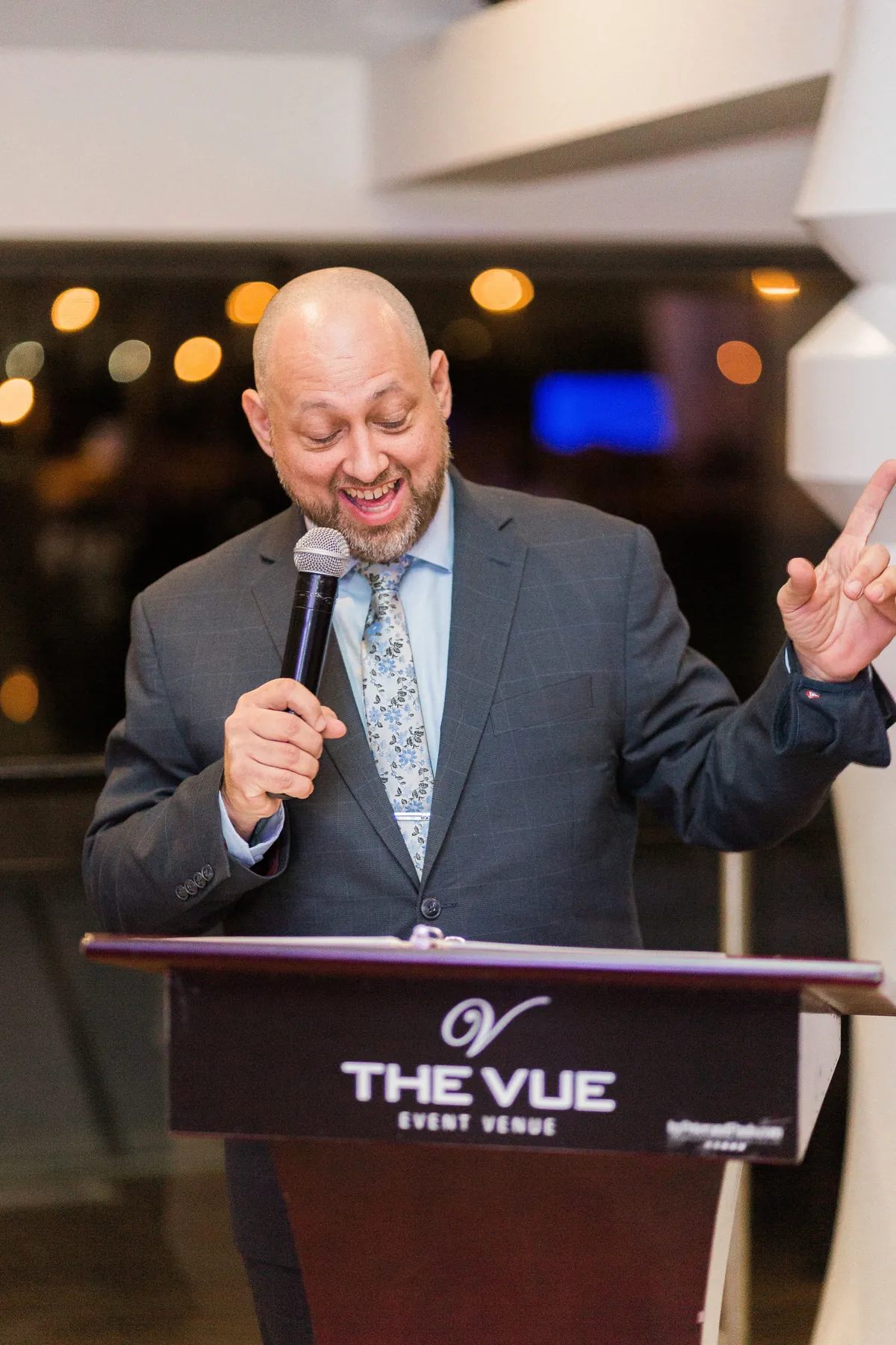 Joe Seyler at the microphone hosting a wedding reception