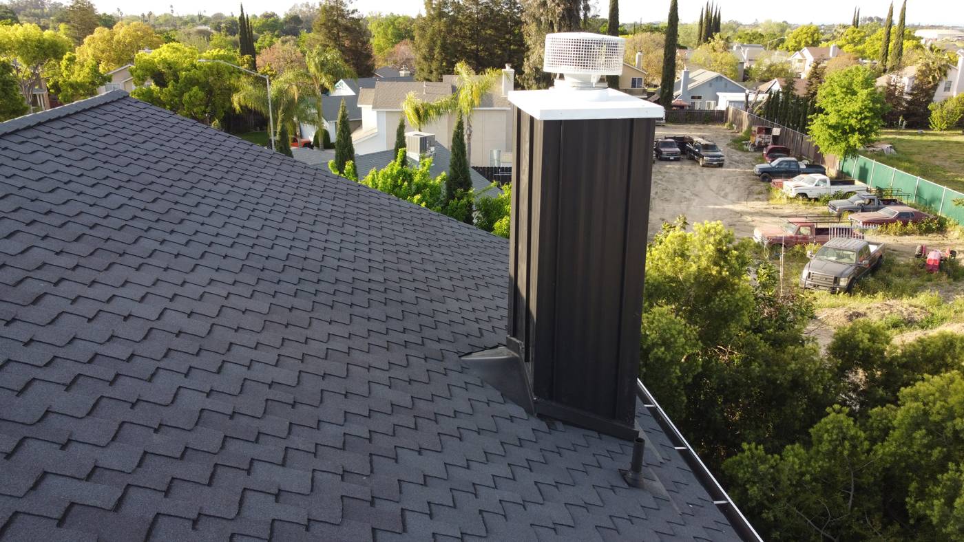 Finished charcoal shingles and chimney detail