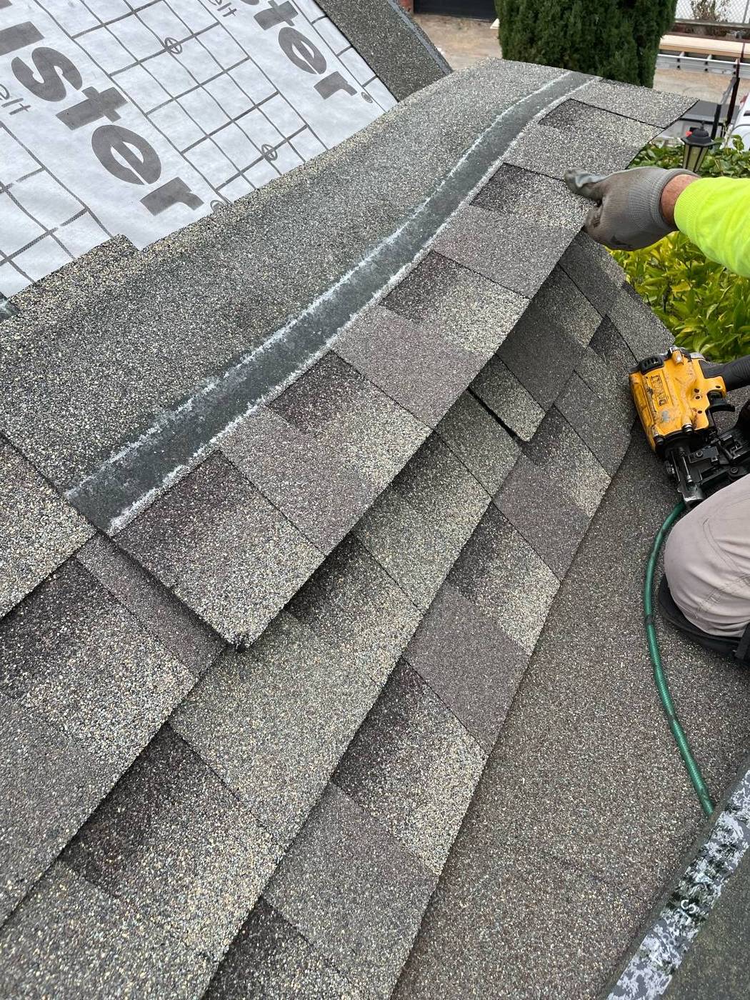 Yellow DeWalt coil gun on a roofing job