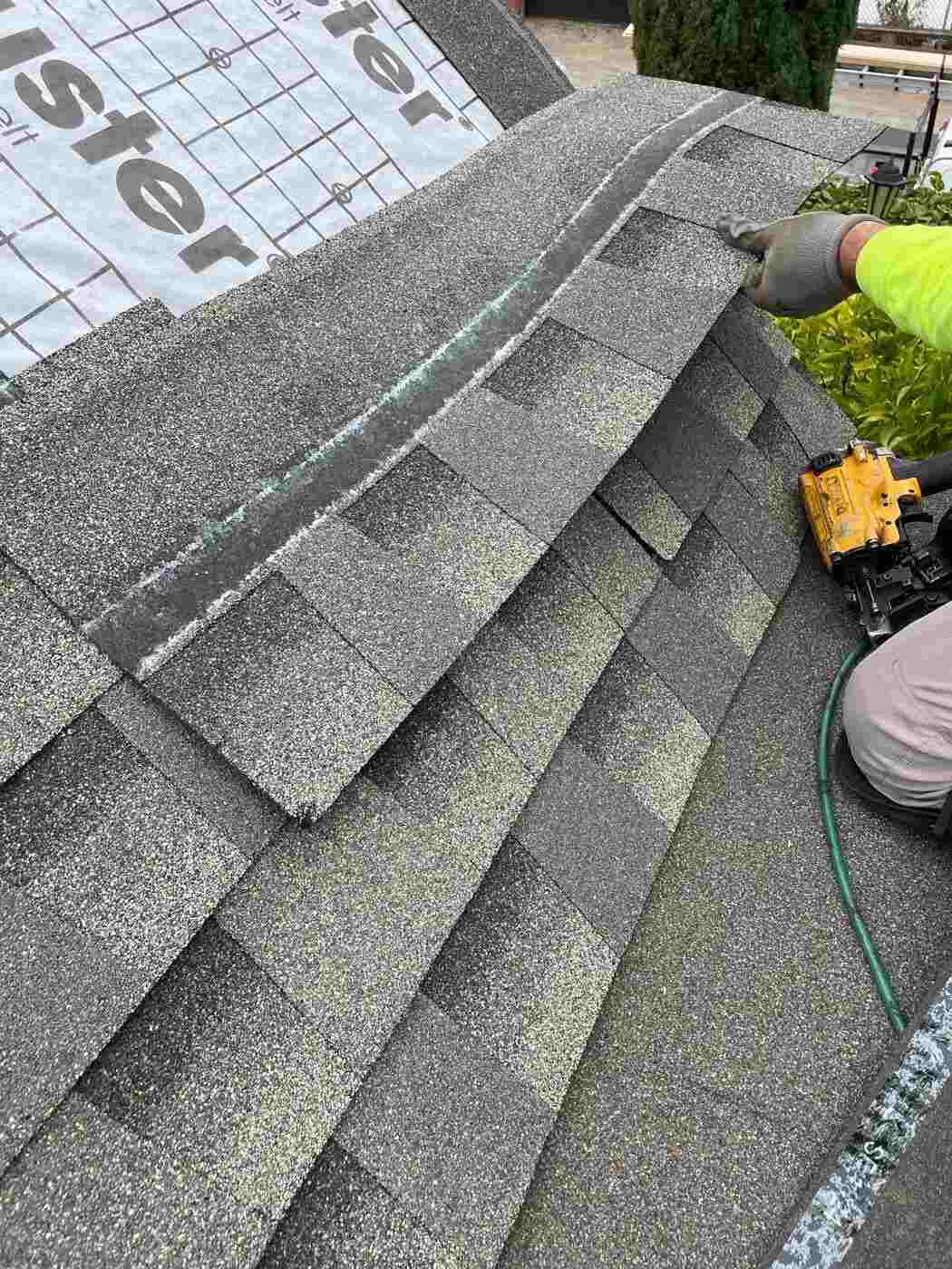 Yellow DeWalt coil gun on a roofing job