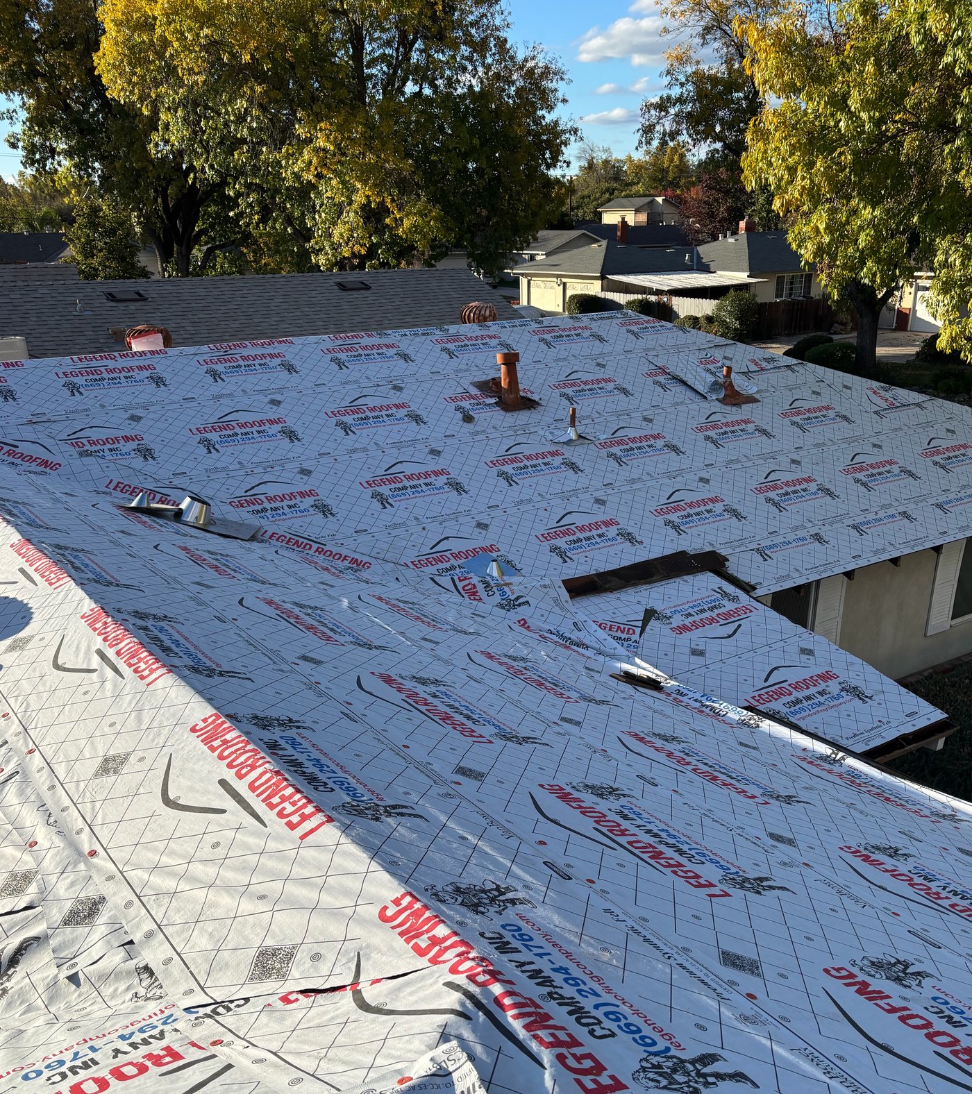 Legend Roofing Company Inc branded underlayment installed across multiple roof planes during a reroof
