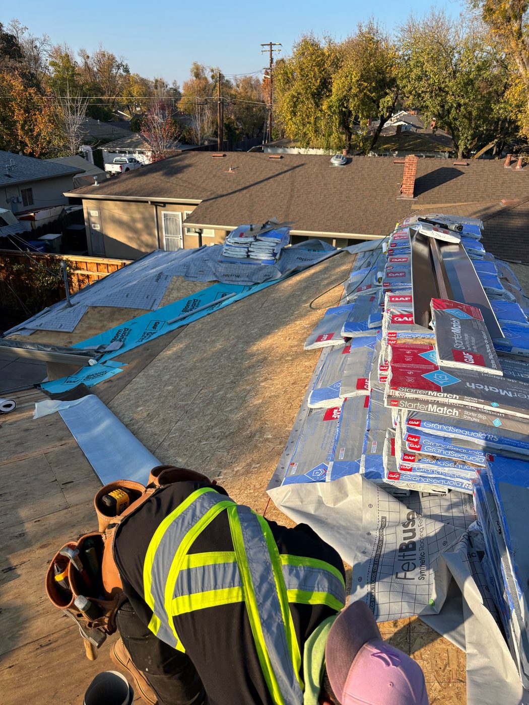 Modesto roof dry-in with bright blue GAF StormGuard self-adhered leak barrier along the edge