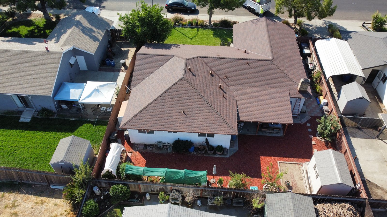 Finished Riverbank roof in GAF Timberline architectural shingles in Hickory, seen from above, with the yard cleaned up after the job