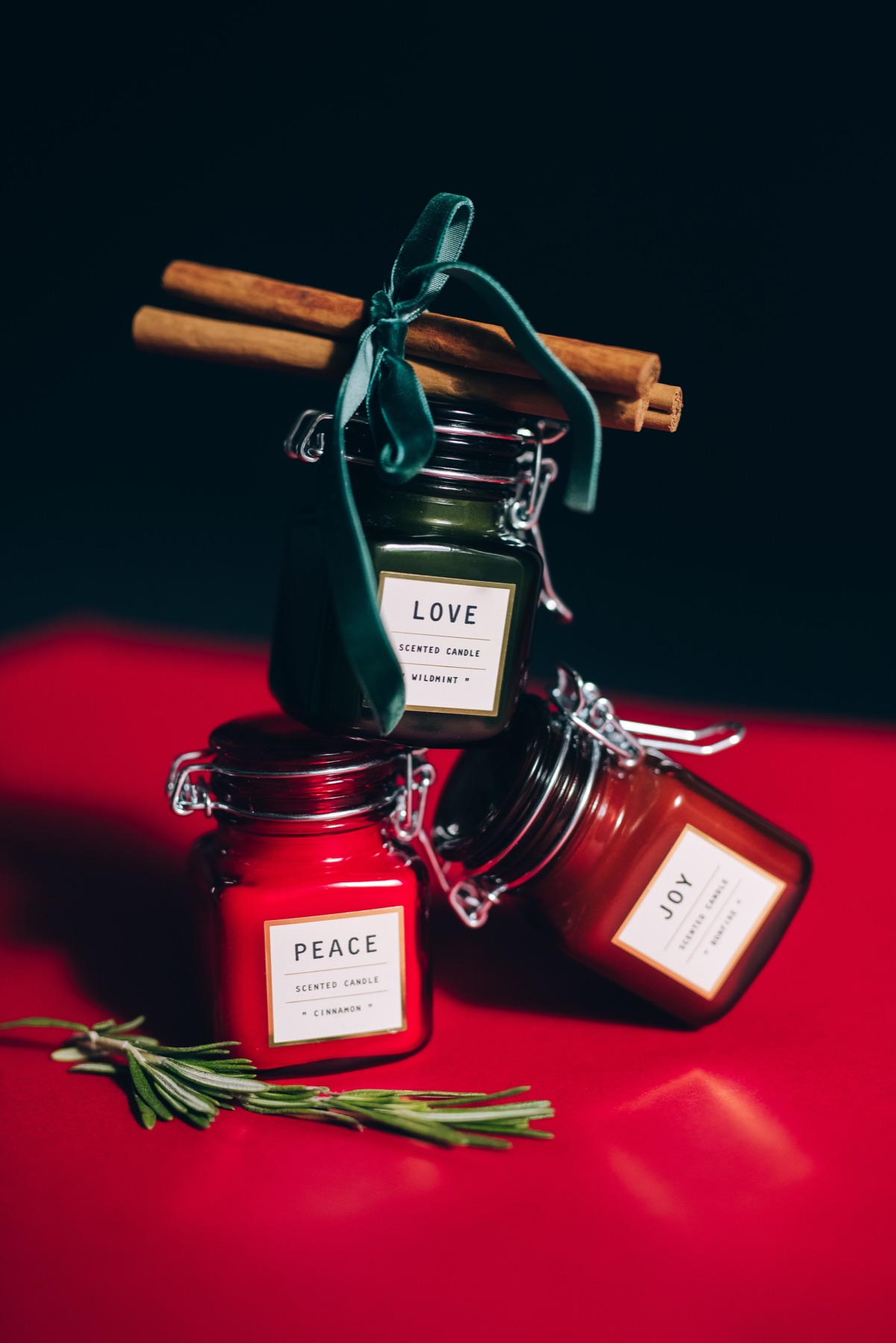 Art-directed candle product photography in rich red and green