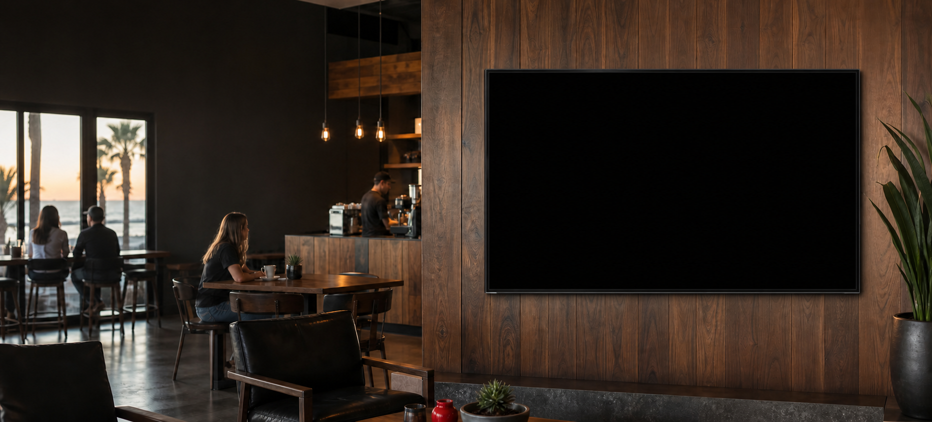 Modern coastal coffee lounge with a front-facing Adventure Media network display