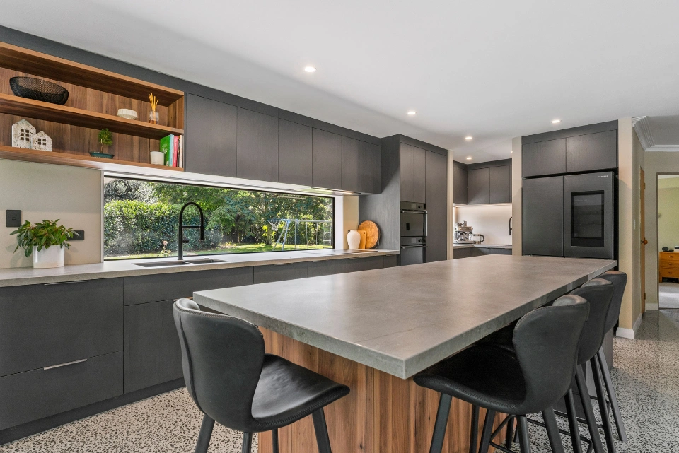 Custom-designed kitchen in Tauranga featuring stone benchtops and island seating