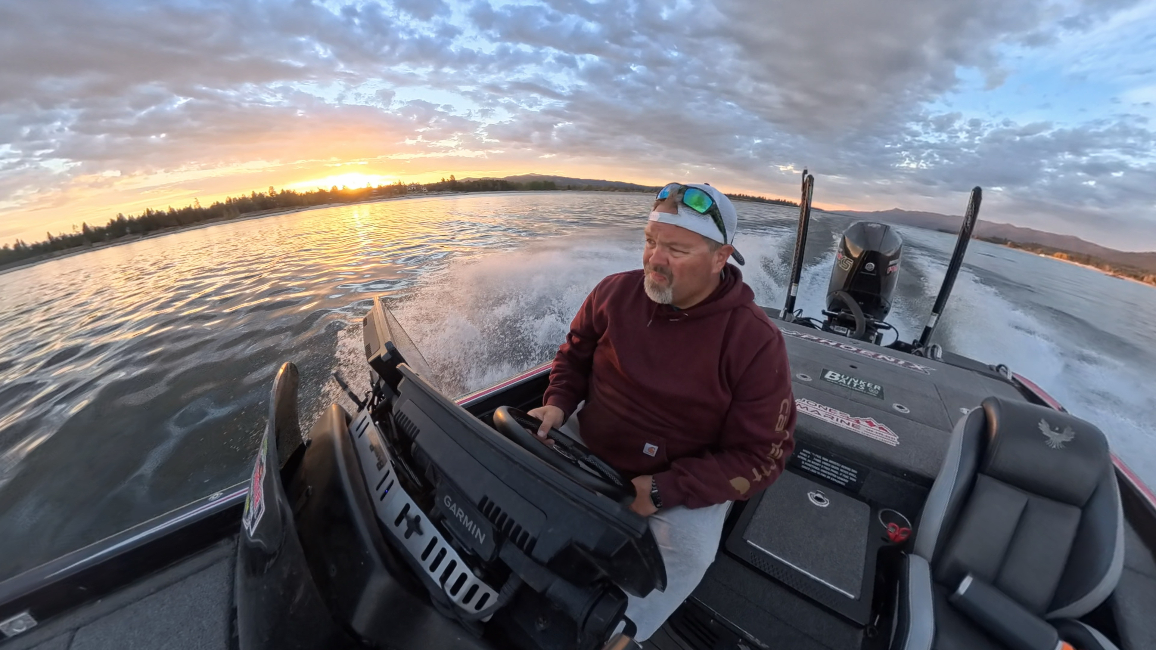 Sam at the wheel of his bass boat at sunrise