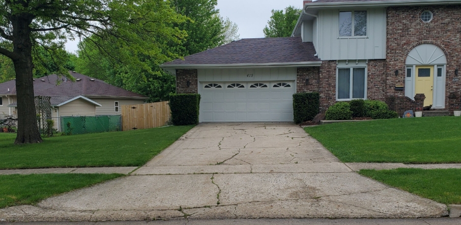 Old cracked concrete driveway before replacement