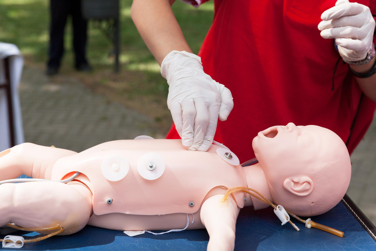 Instructor practising CPR on a baby mannequin
