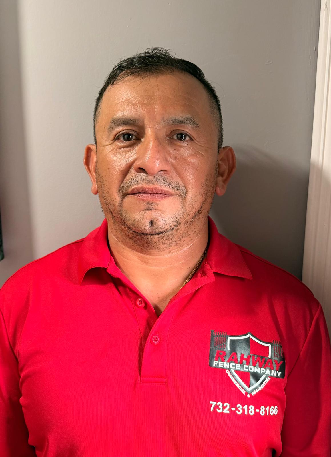 Abel, founder of Rahway Fence Company, in a company polo shirt