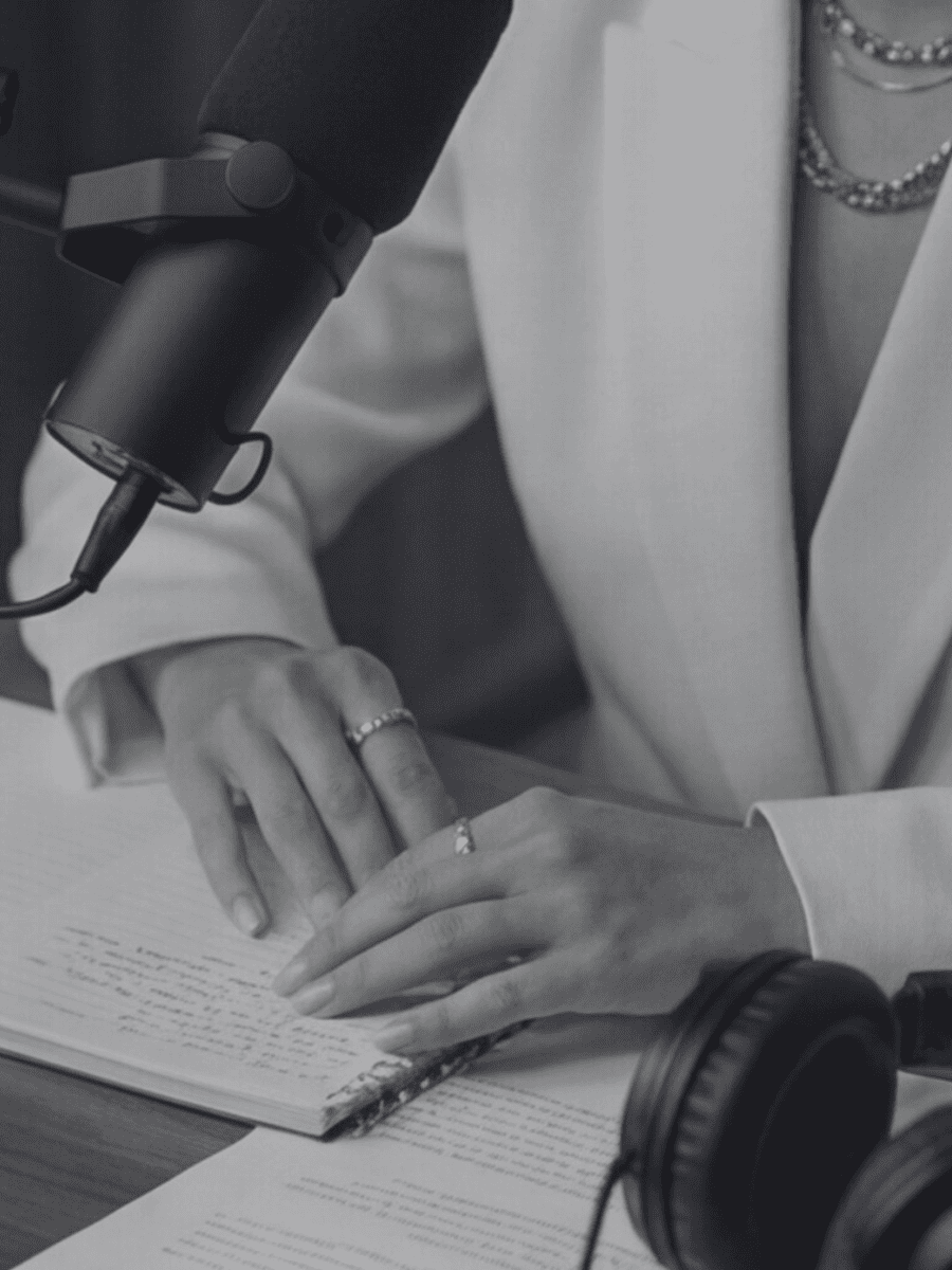 Woman recording a podcast at a professional studio desk