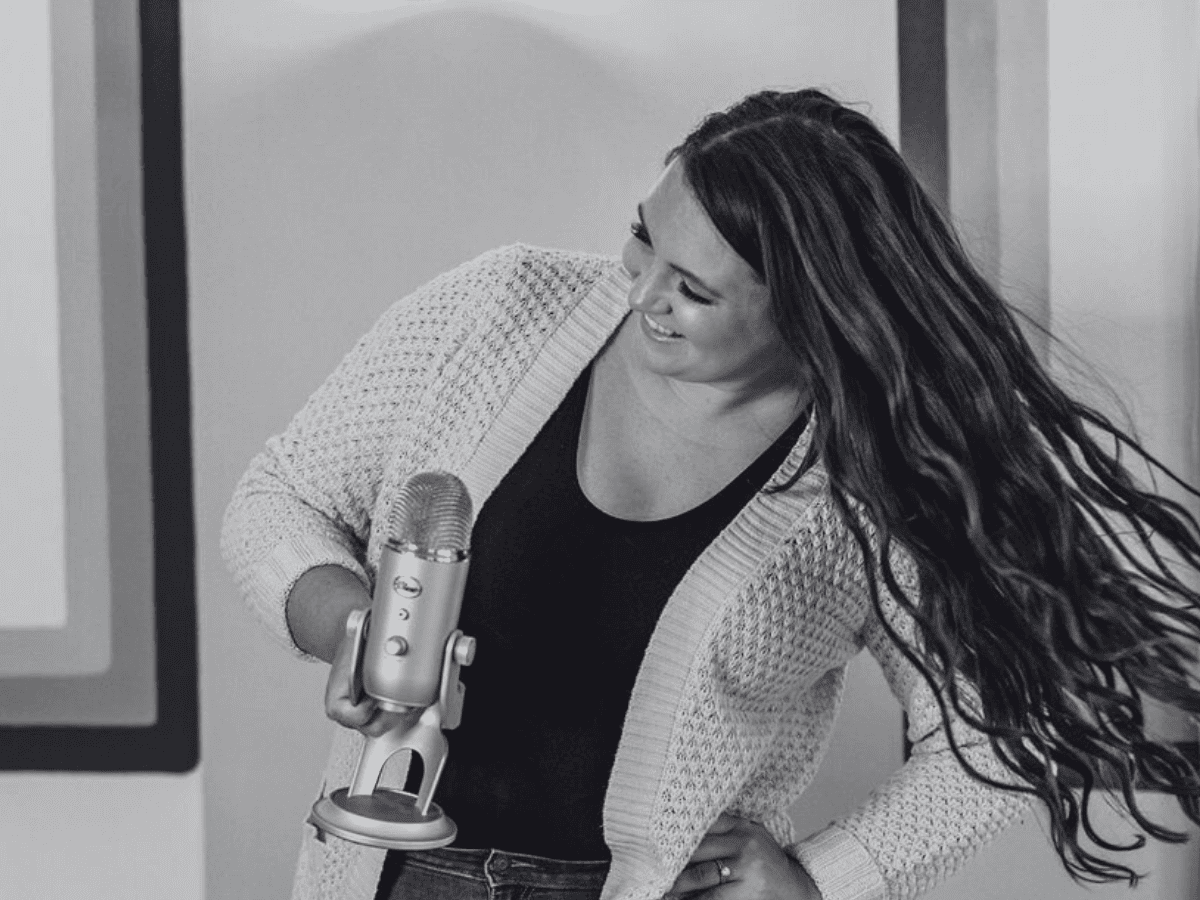 Podcast recording setup with microphone and warm studio lighting