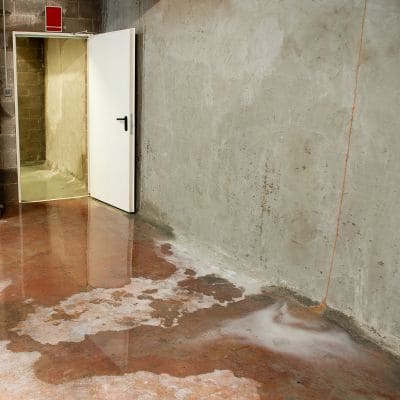 Flooded concrete floor near open door