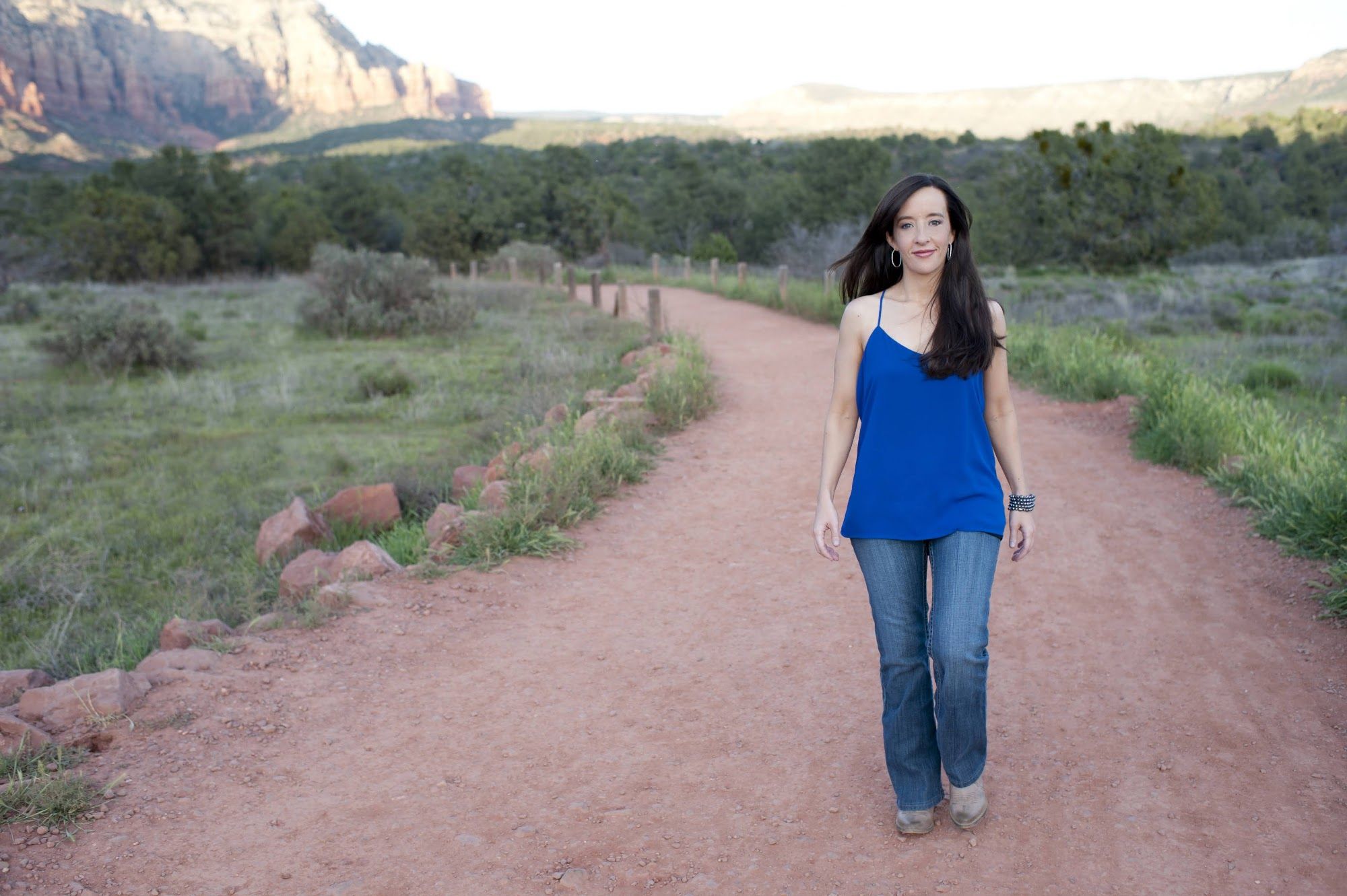 Mindie walking a red dirt trail in Sedona