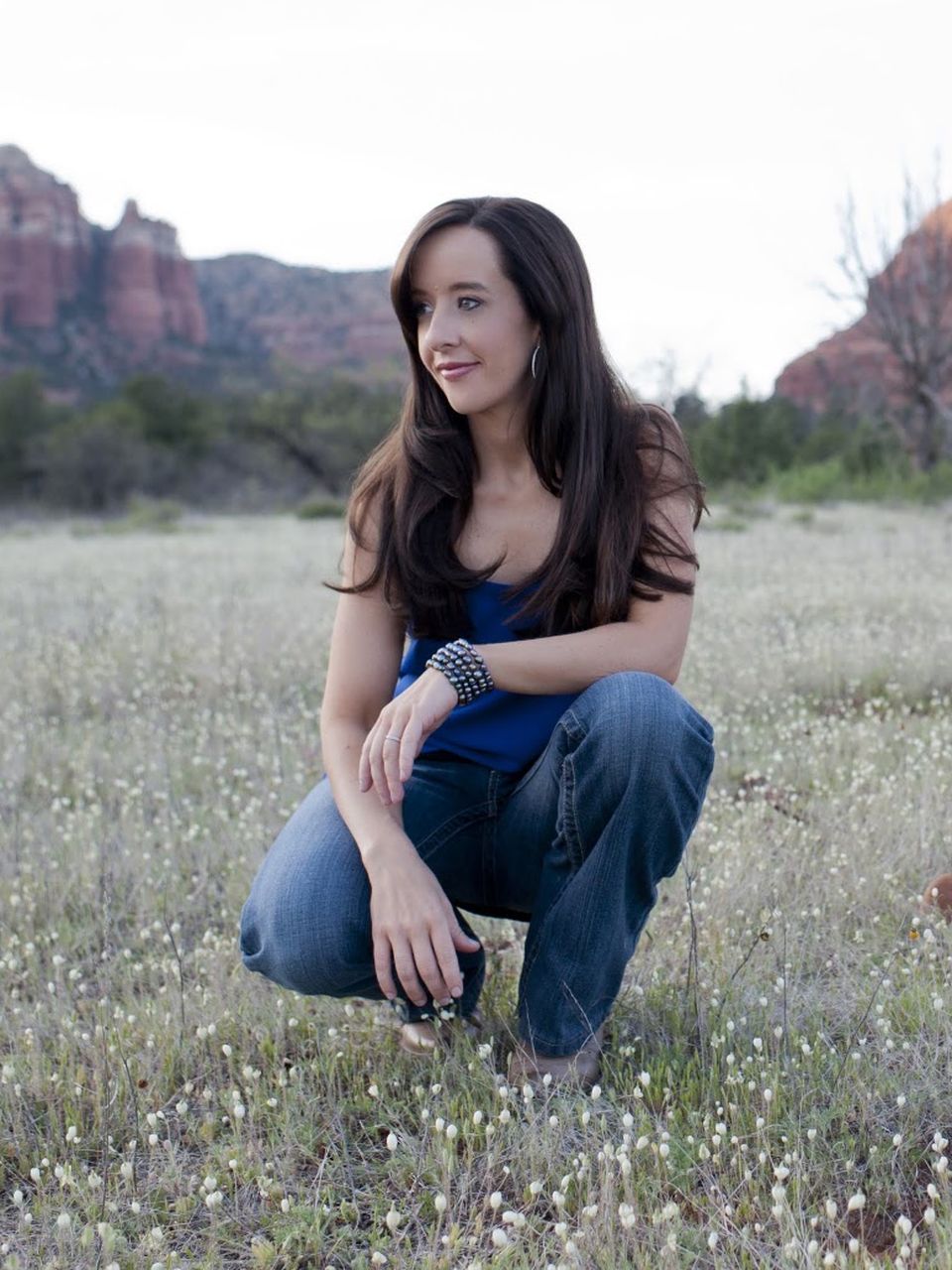Mindie Kniss crouching in a wildflower field in Sedona