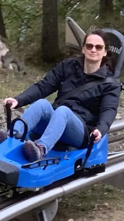 Bridget sliding down a mountain on a bob coaster