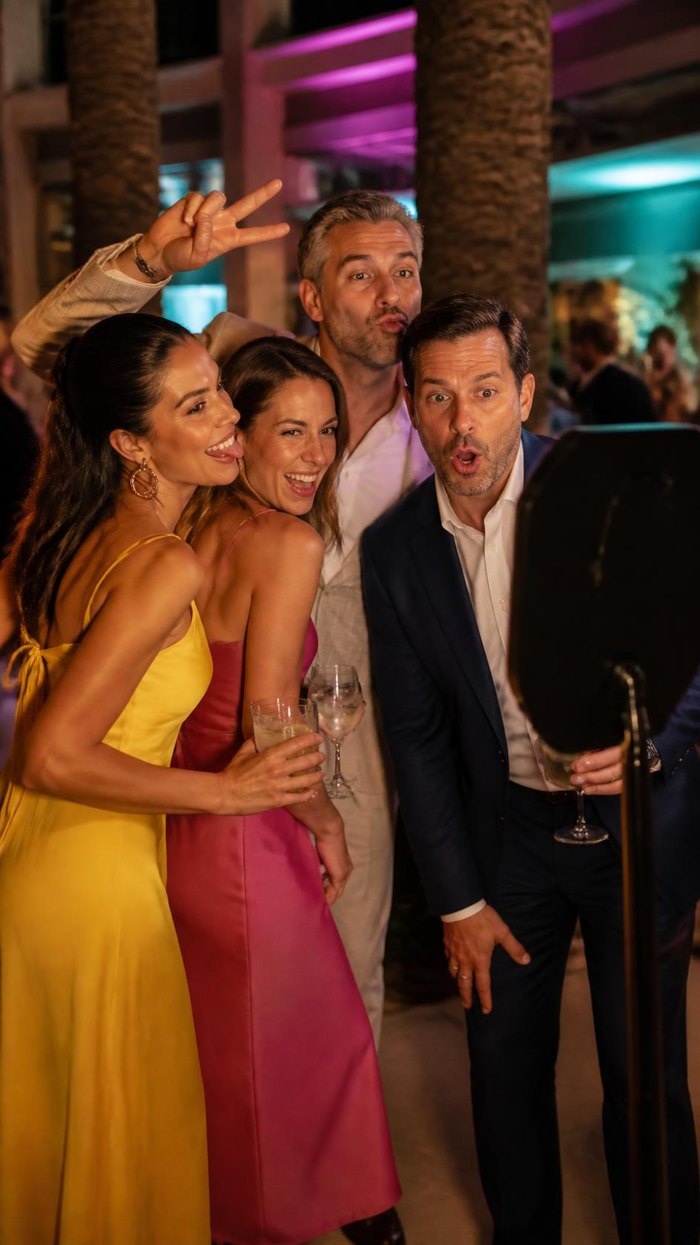 Guests laughing and posing together at a private event photo booth