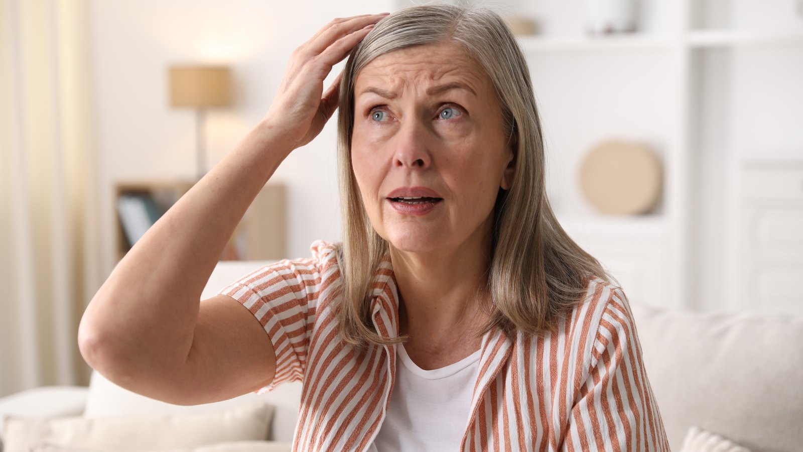 Older woman trying to remember something