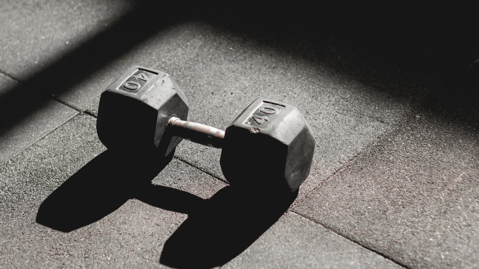 Dumbbell resting on a gym floor