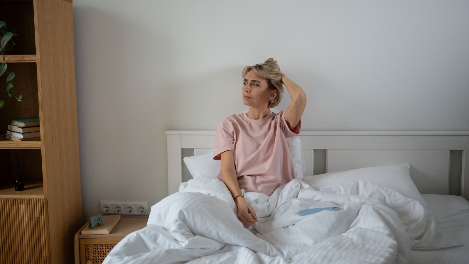 Woman sitting up awake in bed