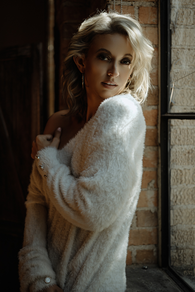 A portrait by the window in Catherine Cooper's Dallas studio
