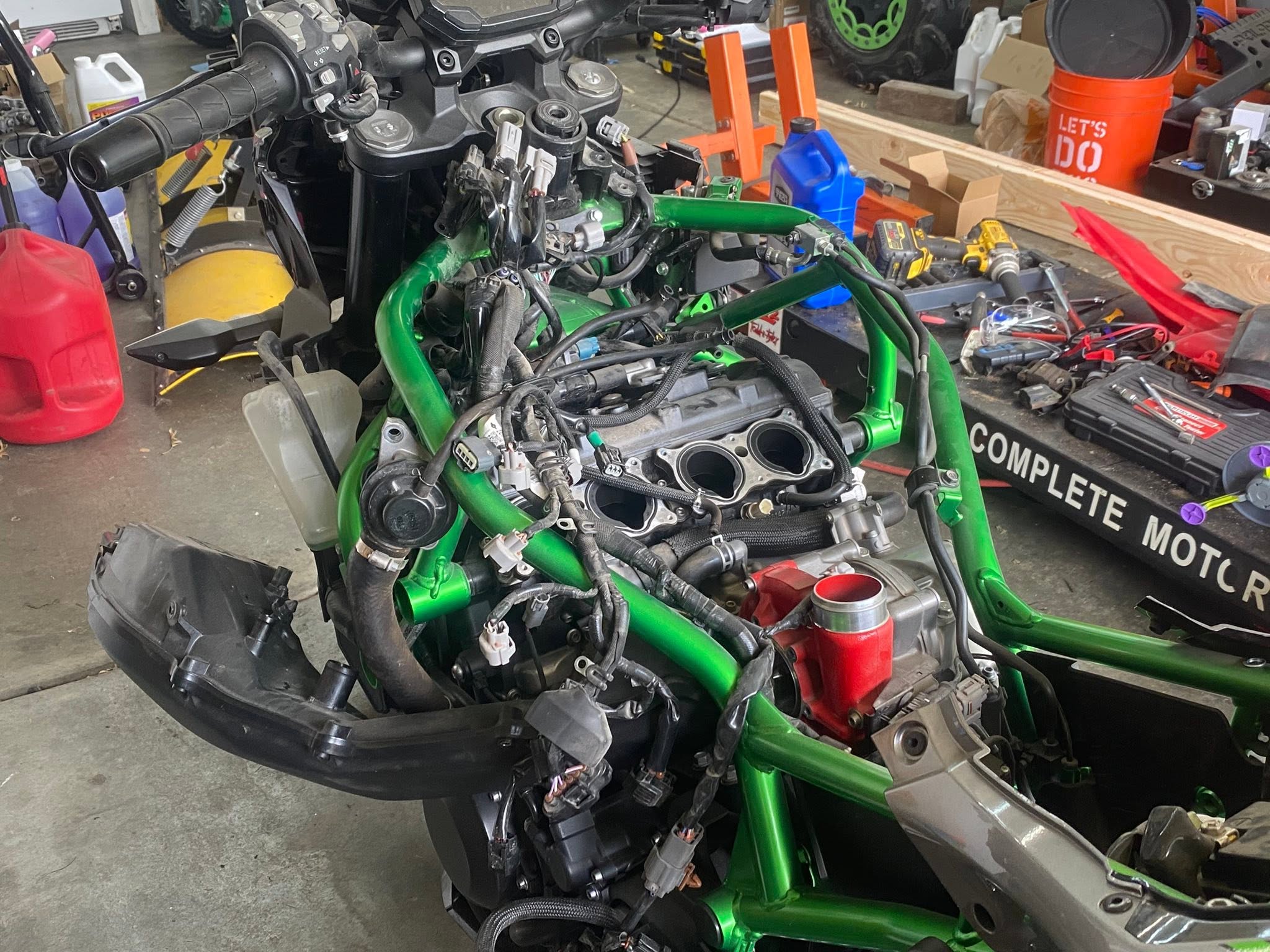 Powersports engine repair work in progress on a green frame machine